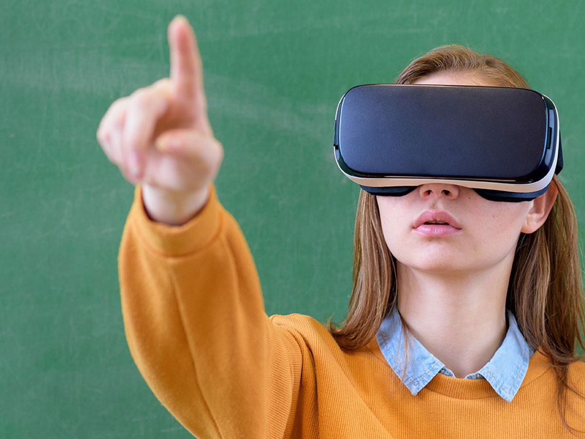 A female student interacts with a virtual headset.
