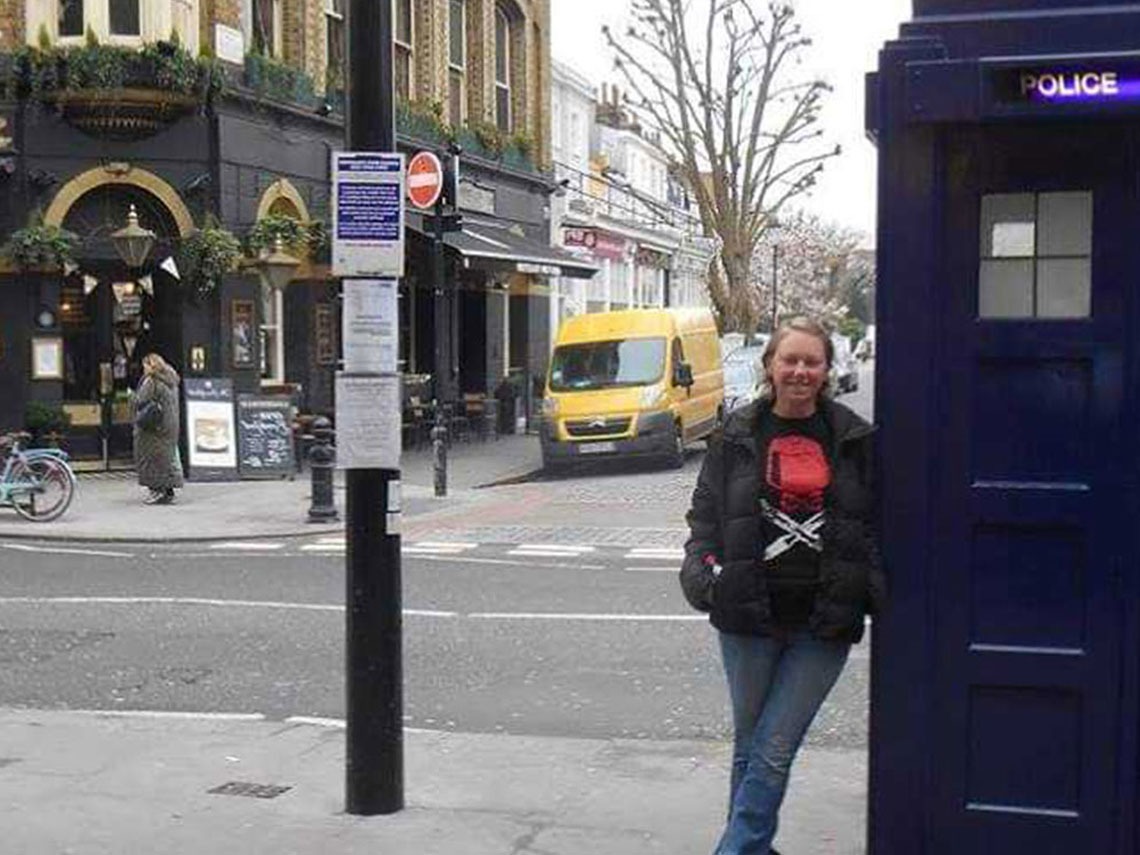 Professor Strange poses in front of a police booth in England.